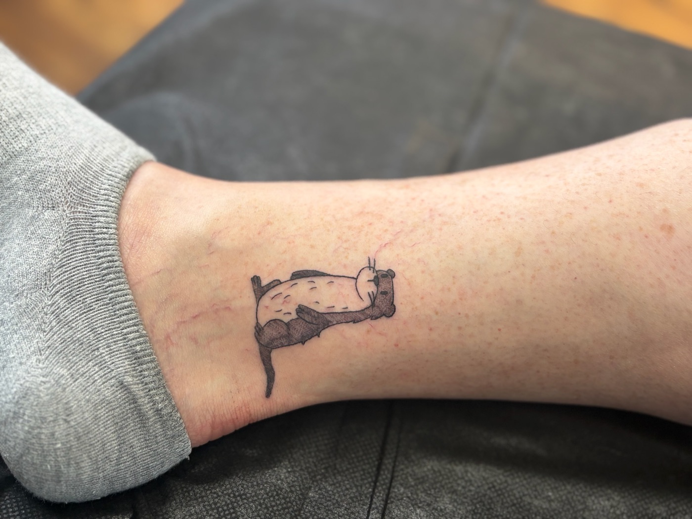 Smiling capybara fine line tattoo by Caitlyn Barbosa