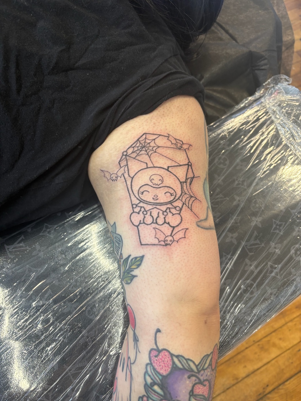 Cute bat holding umbrella fine line tattoo by Caitlyn Barbosa