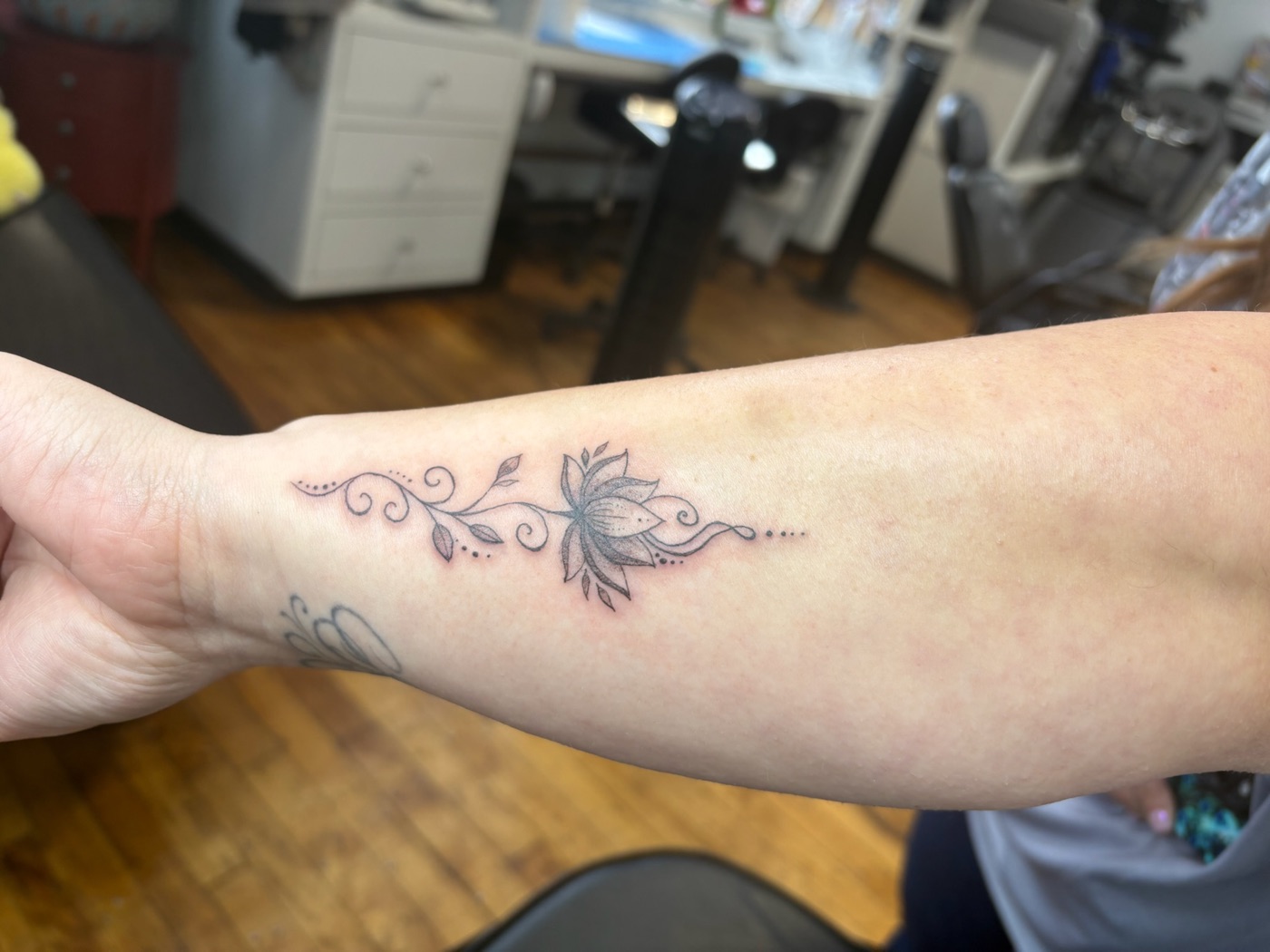 Decorative floral vine fine line tattoo by Caitlyn Barbosa
