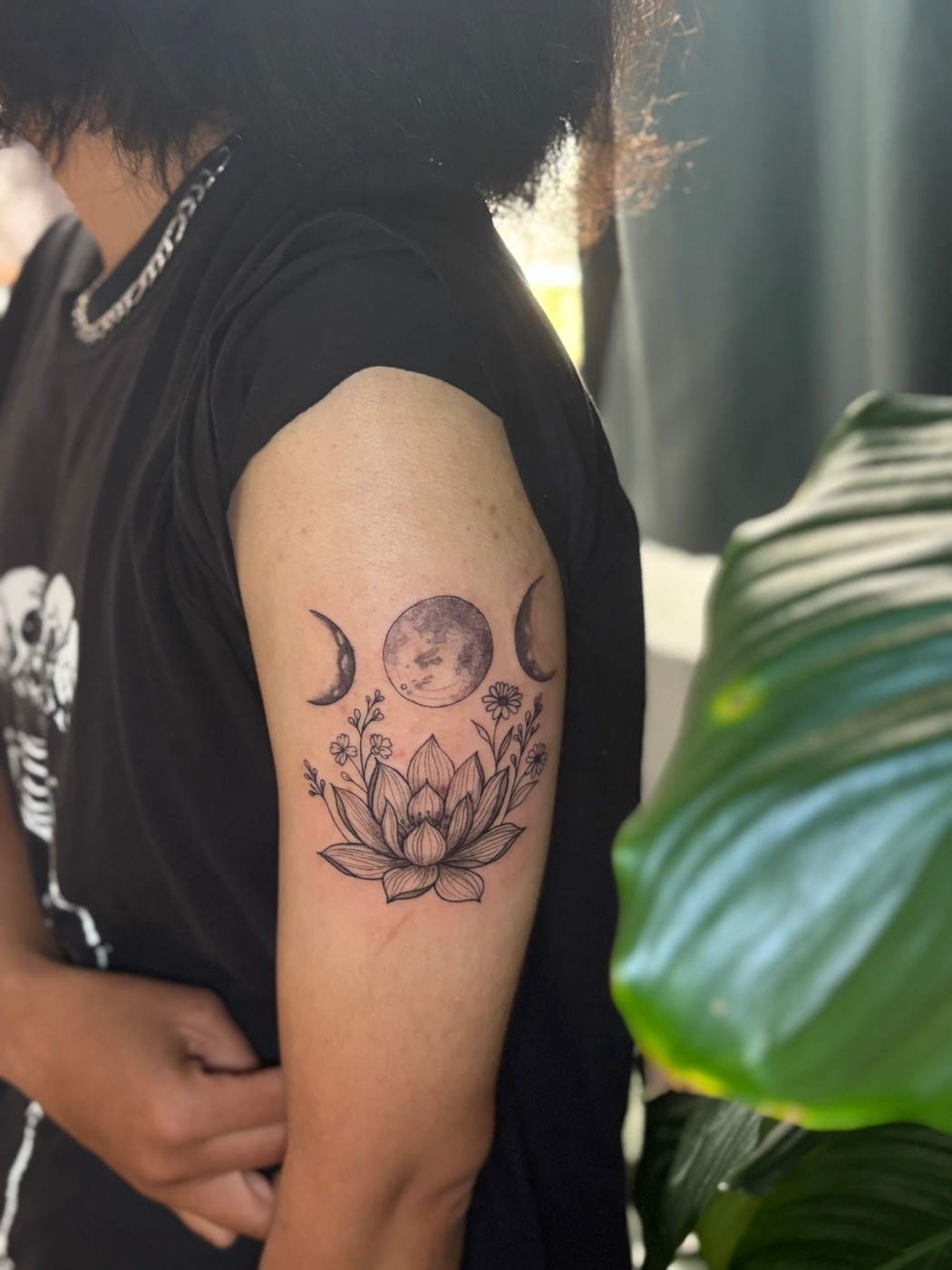 Moon phases and lotus flower fine line tattoo by Caitlyn Barbosa