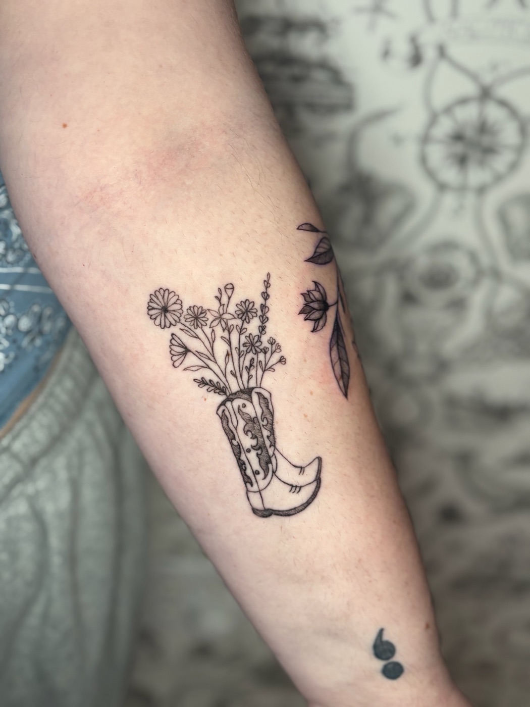 Wildflower bouquet in boot fine line tattoo by Caitlyn Barbosa