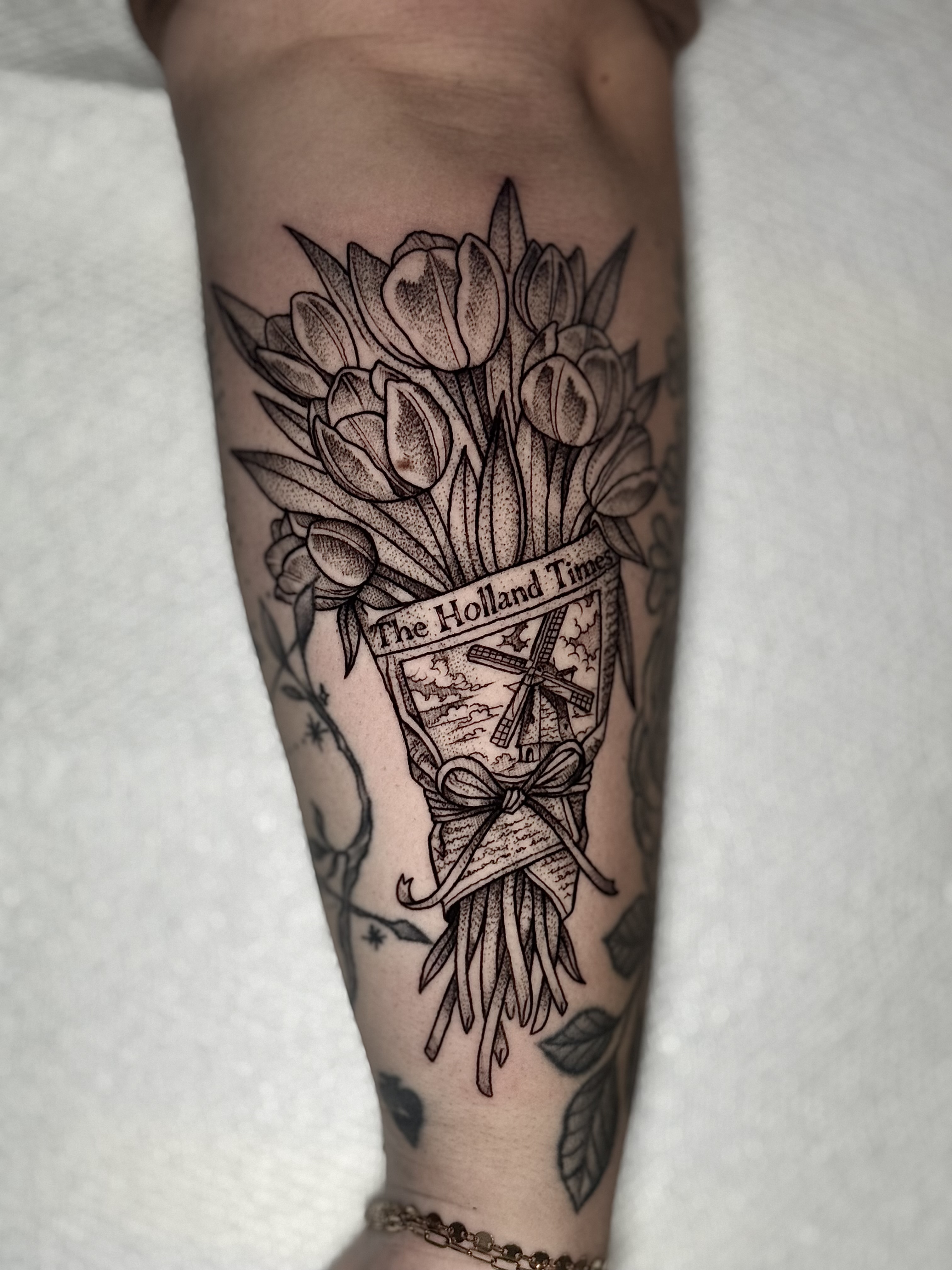 Dutch tulips in newspaper with windmill tattoo by Julia Harley