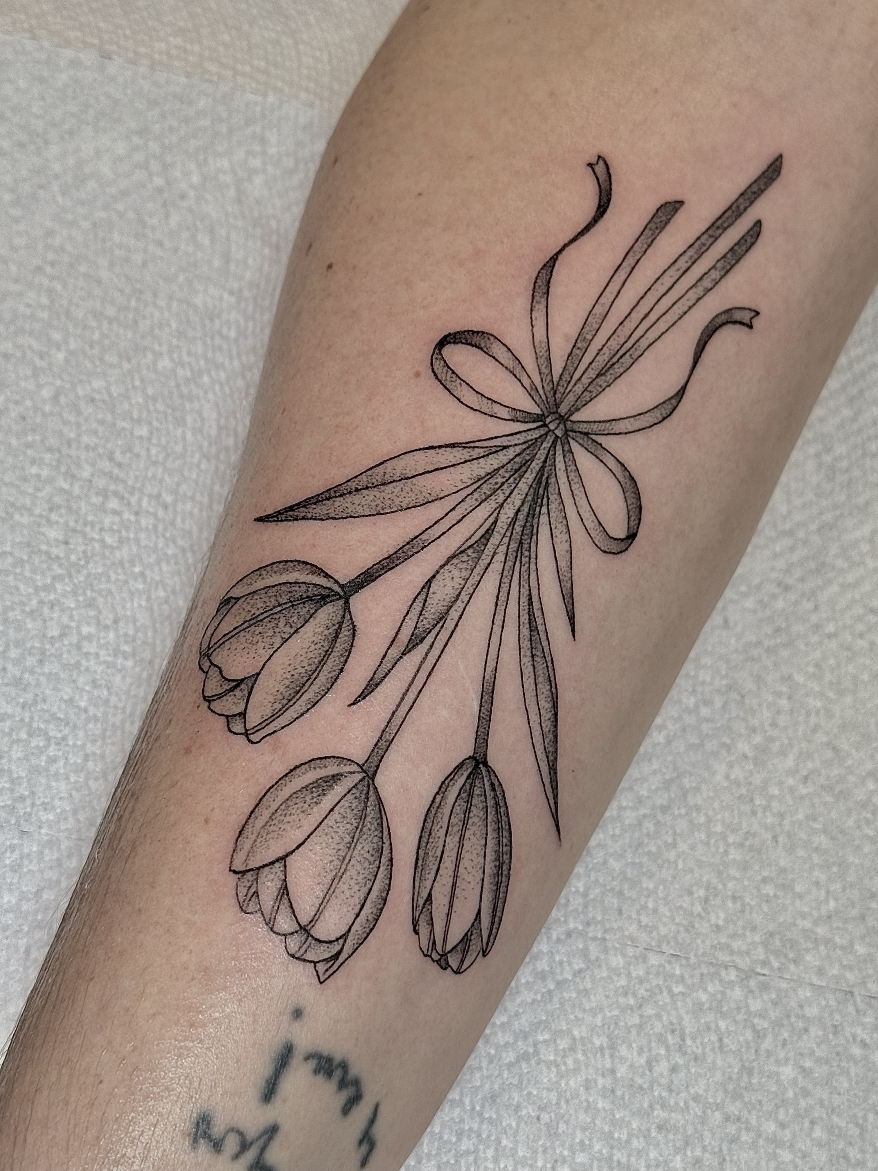 Fine line tulip bouquet tattoo design by Julia Harley